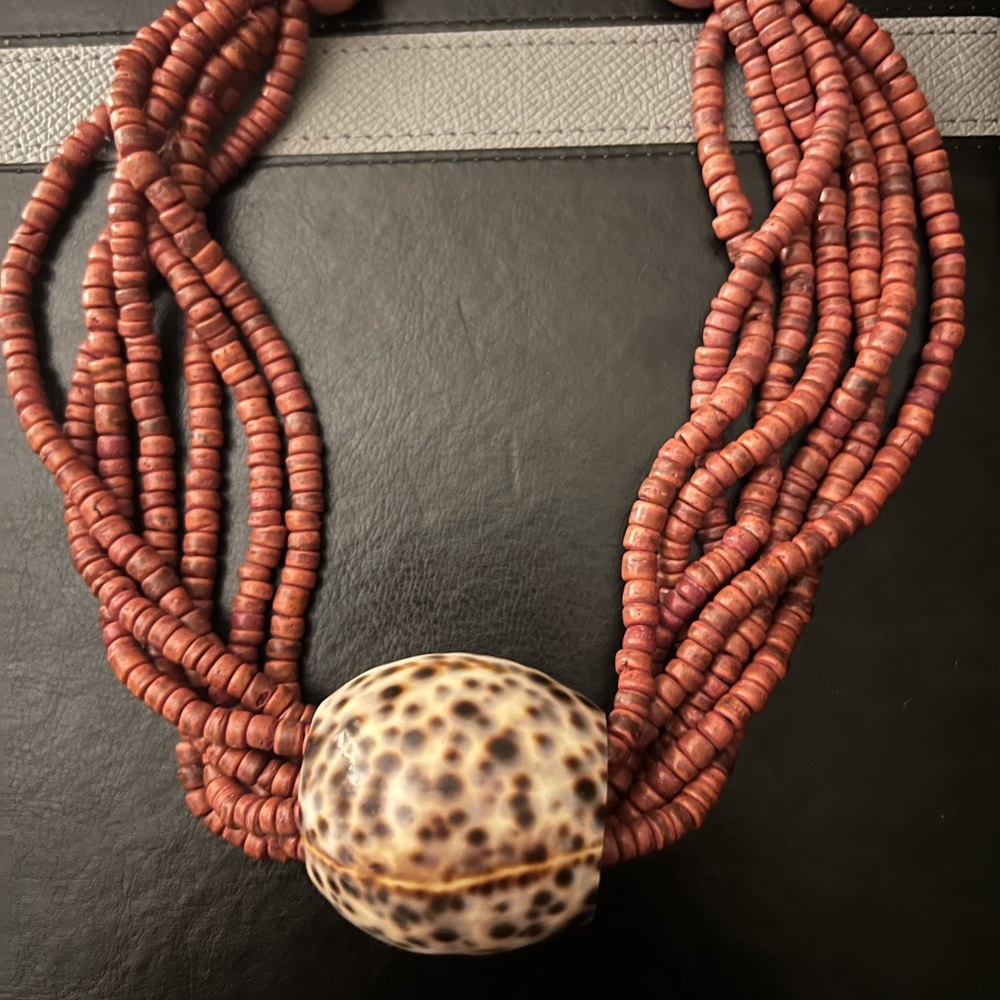 Multi strand bead necklace with large shell pendant